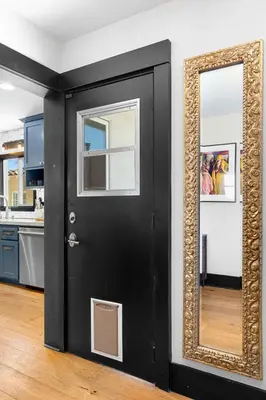 a black door with a mirror in a kitchen at Charming 2BR in Heart of LA with Spacious Backyard in Los Angeles