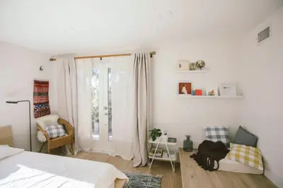a bedroom with a bed and a chair and a window at Private and Quiet Los Feliz Guest Suite with VIEWS in Los Angeles