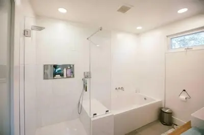 a white bathroom with a tub and a shower at Private and Quiet Los Feliz Guest Suite with VIEWS in Los Angeles