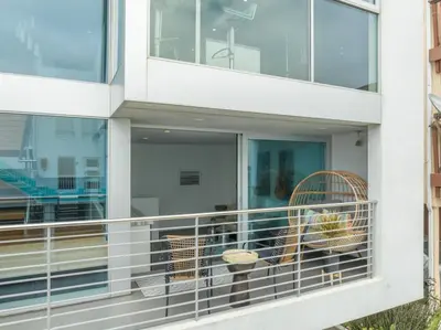 a balcony of a building with two chairs at The Blue Wave - 3 blocks from Manhattan Beach Pier in Manhattan Beach