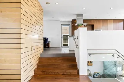 a staircase leading to the kitchen and living room of a house at The Blue Wave - 3 blocks from Manhattan Beach Pier in Manhattan Beach