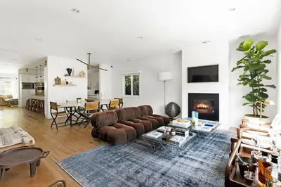 a living room with a couch and a fireplace at Luxury Melrose District 3BR Retreat Pool Spa Gym in Los Angeles