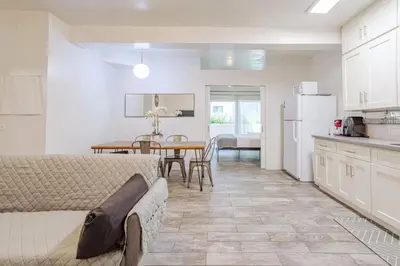 a kitchen and living room with a couch and a table at Westwood UCLA 2BR, 1BA Cozy Condo w Amenities in Los Angeles