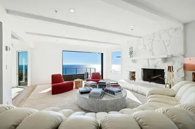 a living room with a couch and a fireplace at Luxe Malibu Retreat - Ocean Views, Hot Tub and Gym in Malibu