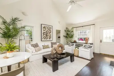 a living room with a couch and a table at Chic Beach Bungalow 3 Blocks from the Sand in Manhattan Beach