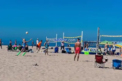 a group of people playing volleyball on the beach at Chic Beach Bungalow 3 Blocks from the Sand in Manhattan Beach