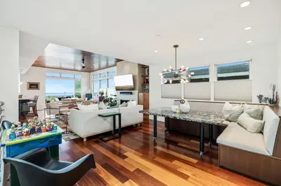 a living room with a couch and a table at Lux by Manhattan Beach Pier and Panoramic Ocean View in Manhattan Beach