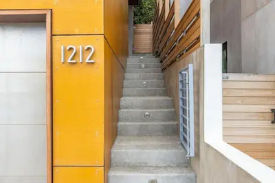 a stairway with a door with the number on it at Lux by Manhattan Beach Pier and Panoramic Ocean View in Manhattan Beach