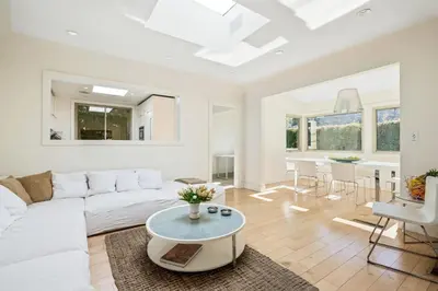a living room with a white couch and a table at Private Designer Home in West Hollywood in Los Angeles