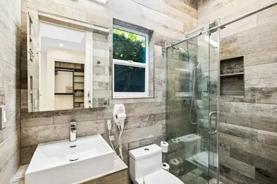 a bathroom with a toilet and a sink and a shower at Private Designer Home in West Hollywood in Los Angeles