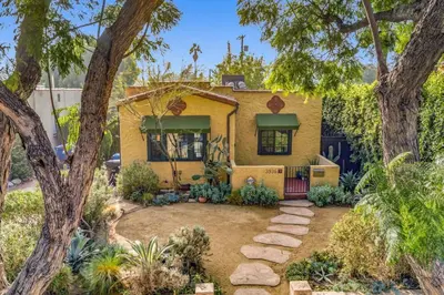 a yellow house with trees and a yard at Atwater Oasis with Pool and HotTub very Walkable Area in Glendale