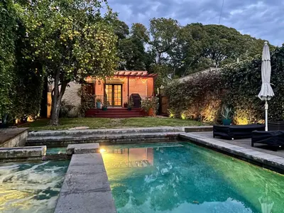 a house with a swimming pool and an umbrella at Atwater Oasis with Pool and HotTub very Walkable Area in Glendale