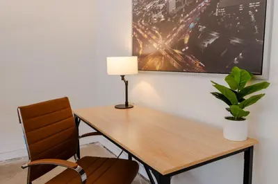 a desk with a lamp and a plant on a wall at Heart of Venice Designer Home Near Abbot Kinney in Los Angeles