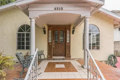 a house with a wooden door and a porch at Russell House Near Hollywood & Griffith Park home in Los Angeles