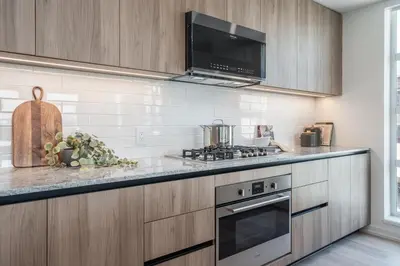 a kitchen with a stove and a microwave at Level Olympic in Los Angeles