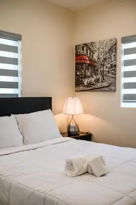 a bedroom with a bed with a towel on it at Modern Getaway Near Pasadena & DTLA in Rosemead