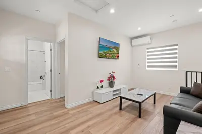 a living room with a couch and a table at Modern Getaway Near Pasadena & DTLA in Rosemead