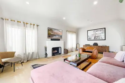 a living room with a couch and a fireplace at Spanish Bungalow in Trendy Los Feliz For Families in Los Angeles
