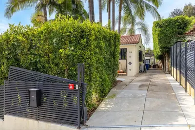 a gate on a sidewalk in front of a house at Spanish Bungalow in Trendy Los Feliz For Families in Los Angeles