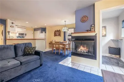 a living room with a couch and a fireplace at The Quiz Cottage Games & BBQ Outdoor Area! in Big Bear Lake
