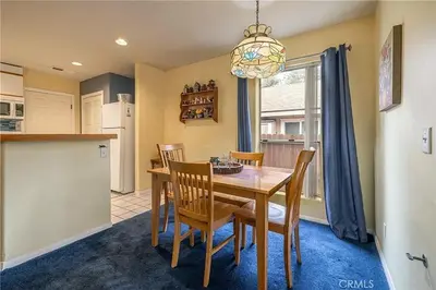 a kitchen and dining room with a table and chairs at The Quiz Cottage Games & BBQ Outdoor Area! in Big Bear Lake