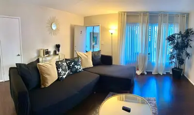 a living room with a couch and a table at Cozy home in Franklin Village, Central location! in Los Angeles