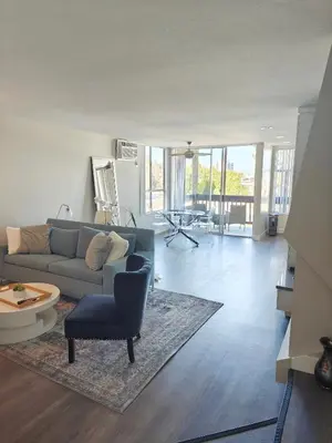 a living room with a couch and a chair at Skyline Escape 1-Bedroom with Balcony and Roof-Top Pool in Los Angeles