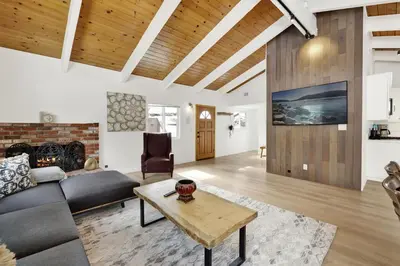 a living room with a couch and a table at Sueños Azules- Fawnskin Retreat Cottage in Big Bear in Fawnskin