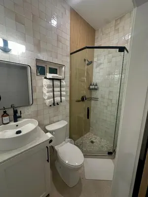 a bathroom with a shower and a toilet and a sink at LA Coastal Oasis in Rancho Palos Verdes