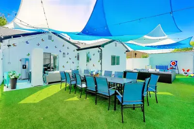 a table and chairs under a tent on a lawn at G- Luxe NoHo Family Home near Universal 15m and Hollywood 10m in Hewitt