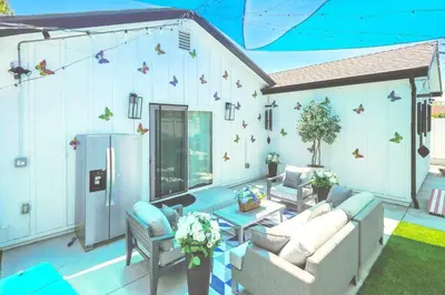 a living room with couches and a wall with butterflies at G- Luxe NoHo Family Home near Universal 15m and Hollywood 10m in Hewitt