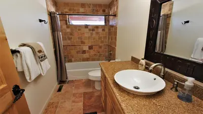 a bathroom with a sink and a toilet and a tub at Lakeside Oasis in Big Bear Lake
