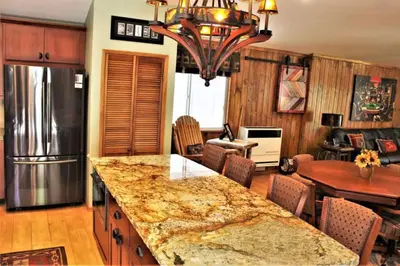 a kitchen with a large granite counter top in a room at Fire Pit & Steps to Village- Village Hideaway in Big Bear Lake