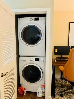 a washer and dryer in a corner of a room at 2 Bed 2 Bath Stylish Luxury Premium High-Rise Apartment in Los Angeles