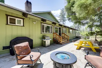a patio of a green house with a table and chairs at Private Hot Tub at Dog-Friendly Lake Arrowhead Gem in Lake Arrowhead