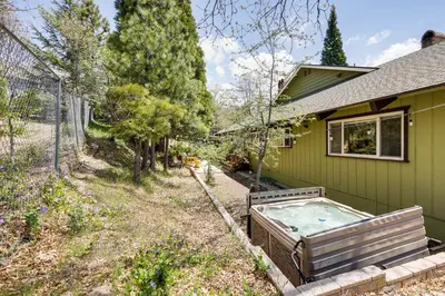 a green house with a hot tub in the yard at Private Hot Tub at Dog-Friendly Lake Arrowhead Gem in Lake Arrowhead