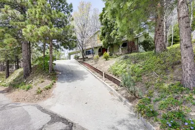 a driveway leading to a house with trees at Private Hot Tub at Dog-Friendly Lake Arrowhead Gem in Lake Arrowhead