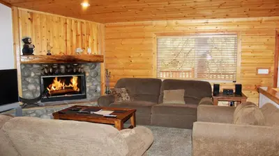 a living room with a couch and a fireplace at Hot Tub/Game Tables/Dogs OK - Aspen Glen in Big Bear Lake