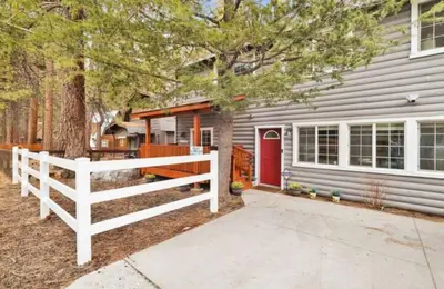 a house with a white fence and a red door at Moab Cozy Lane HotTub & Game Room with Pool Table in Big Bear Lake