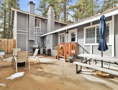 a patio with a table and an umbrella at Moab Cozy Lane HotTub & Game Room with Pool Table in Big Bear Lake