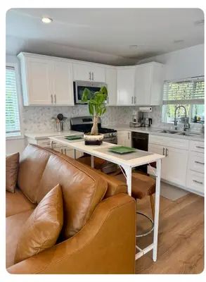a kitchen with a table and a leather couch at PRIVATE modern studio Guesthouse in Los Angeles