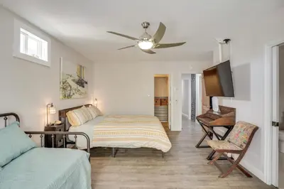 a bedroom with a bed and a flat screen tv at 2 Mi to Cal State Long Beach Bungalow with Hot Tub! in Long Beach