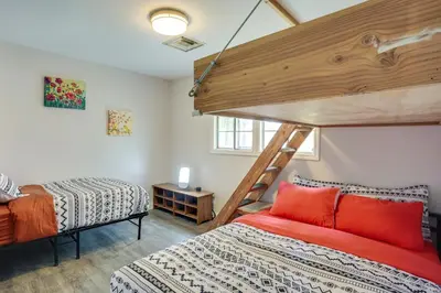 a bedroom with two beds and a loft at 2 Mi to Cal State Long Beach Bungalow with Hot Tub! in Long Beach
