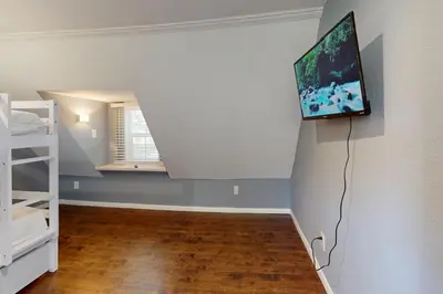 a room with a tv hanging on the wall at Elevation Escape in Lake Arrowhead