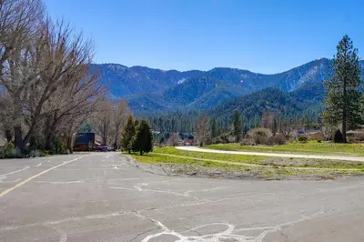 an empty parking lot with mountains in the background at Mountain-View Haven with Deck in Pine Mountain Club in Frazier Park