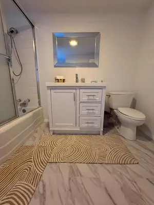 a bathroom with a sink and a toilet and a rug at Serene Lakefront Escape in LA in Lake Hughes
