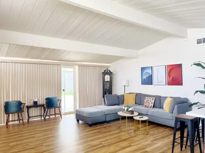 a living room with a blue couch and a table at New Renovated 3B2B house in West Covina