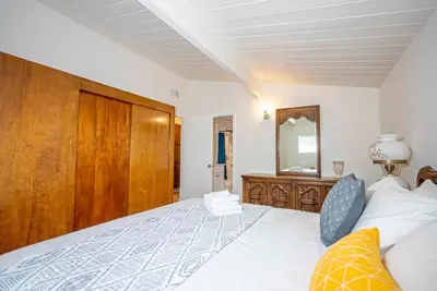 a bedroom with a large bed with a wooden headboard at New Renovated 3B2B house in West Covina