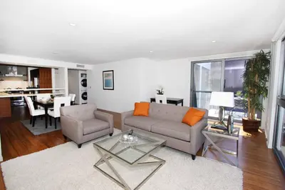 a living room with a couch and a table at Prime Stays - Suite Elegance by MDR Marina & Venice - Pool, Hot Tub, Gym in Los Angeles