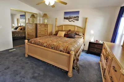 a bedroom with a bed and a dresser and a mirror at Bluebird Cottage in Big Bear Lake